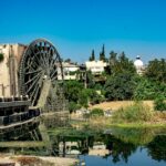 brown and gray concrete building near body of water during daytime