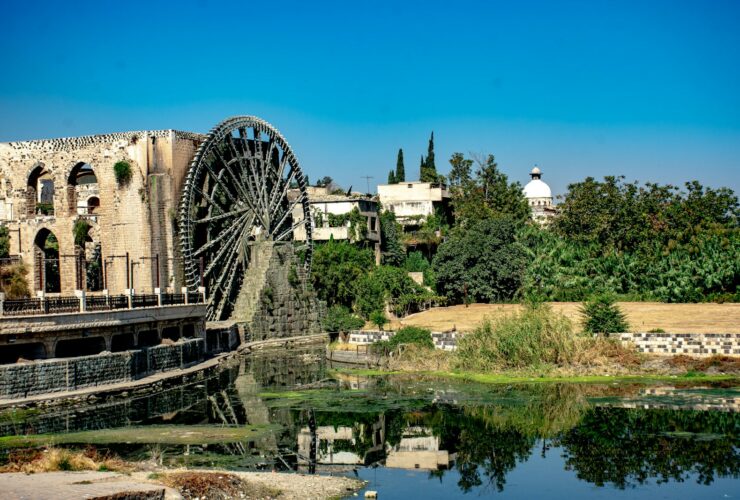 brown and gray concrete building near body of water during daytime