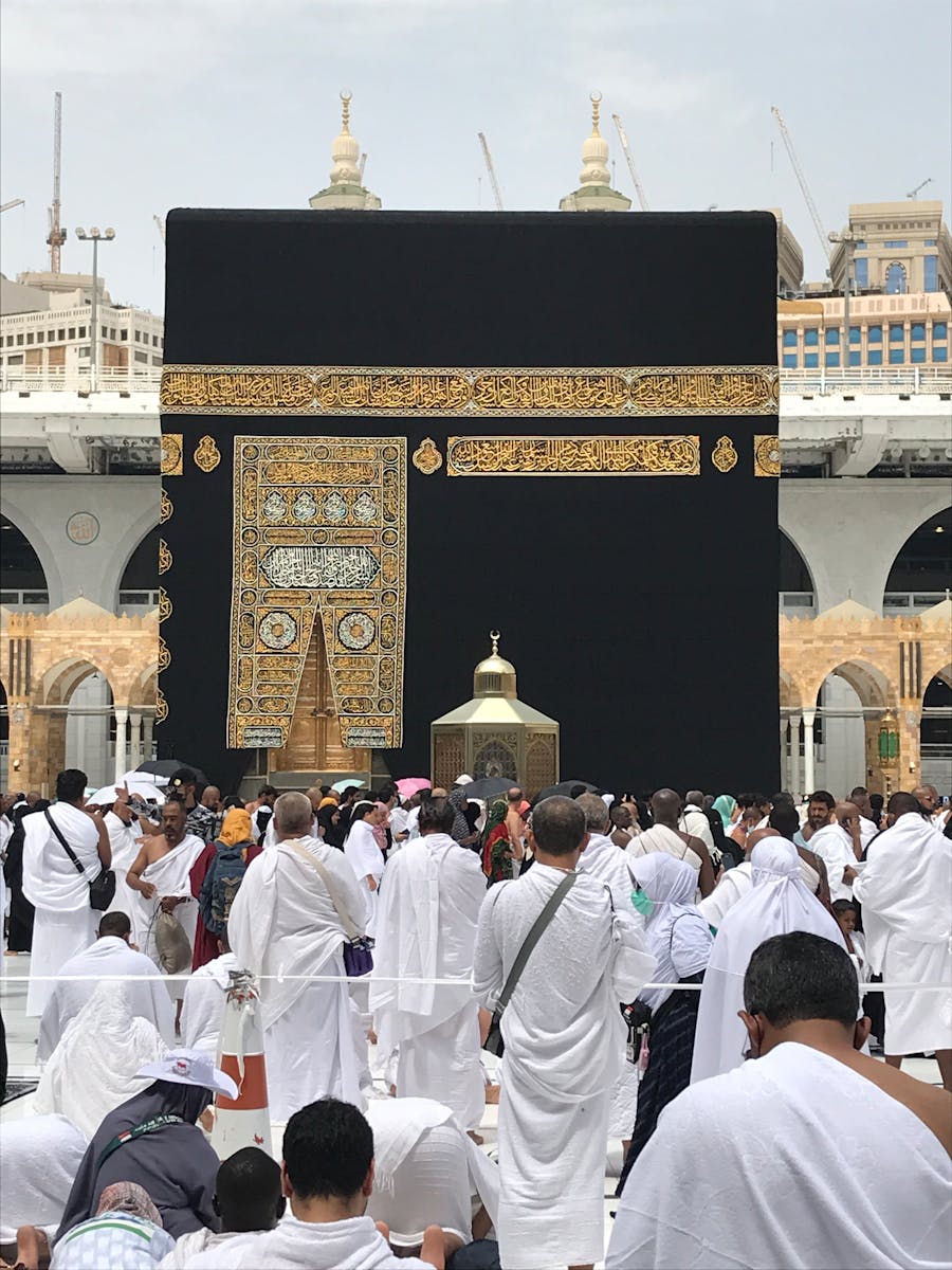 People in White Robe Standing the Stage