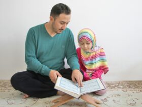 a man reading a book to a little girl