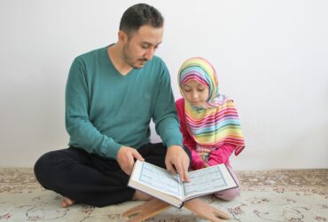 a man reading a book to a little girl
