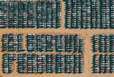 black and red plastic bottles on brown wooden wall