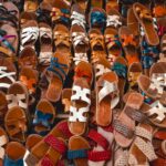 a bunch of shoes that are laying on the ground