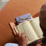 a person reading a book on the floor