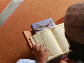 a person reading a book on the floor