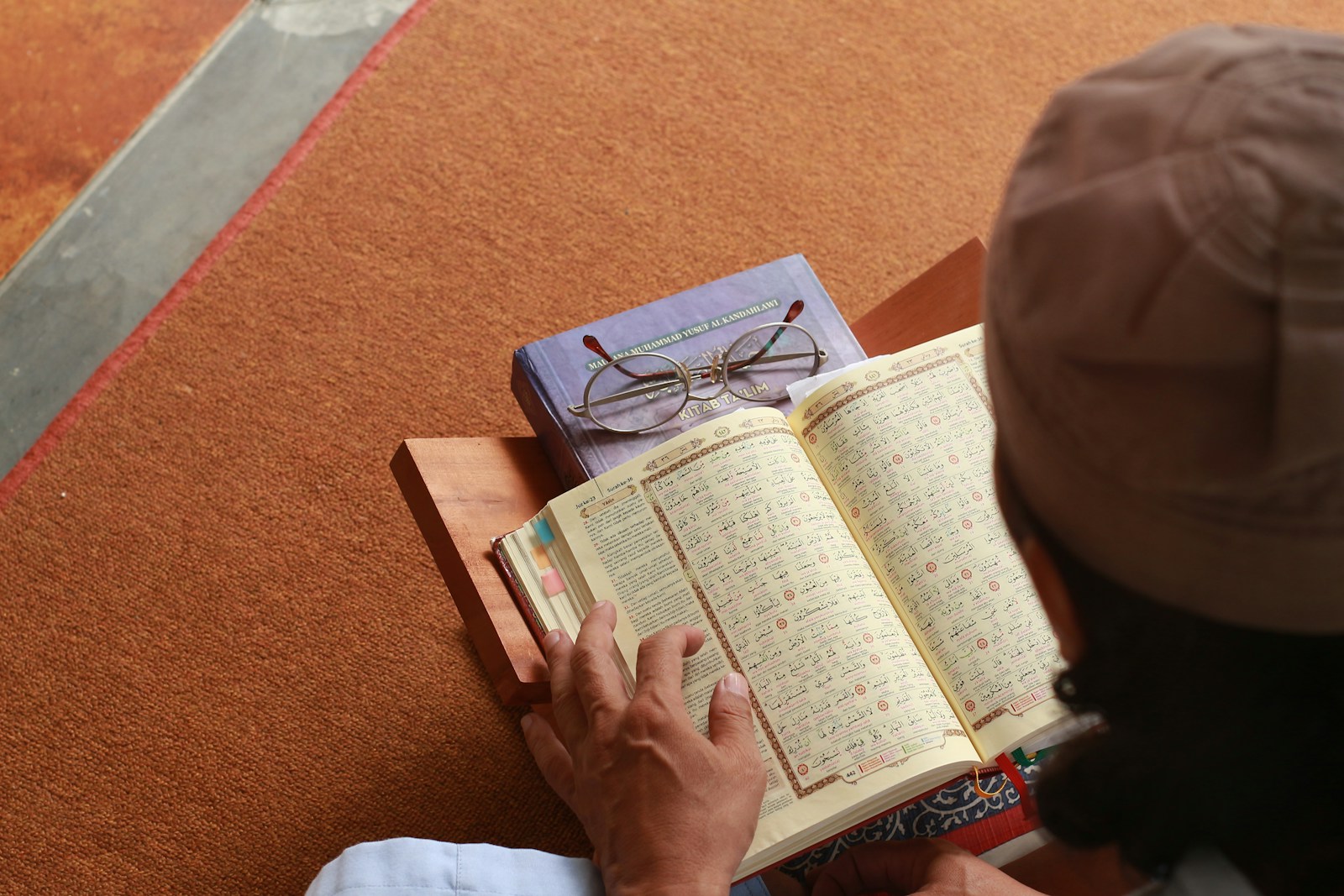 a person reading a book on the floor