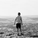 boy standing on field
