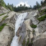 a waterfall in the middle of a rocky area