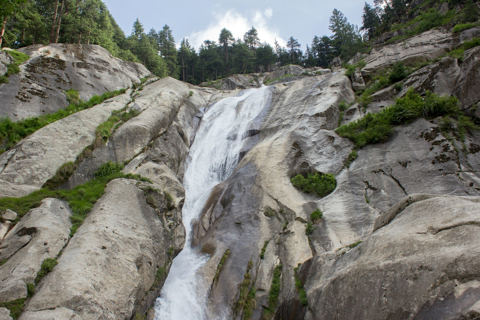 a waterfall in the middle of a rocky area