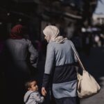 a woman and child walking down a street
