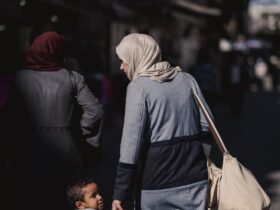 a woman and child walking down a street