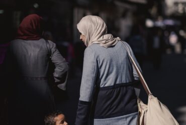 a woman and child walking down a street