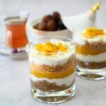 a couple of glasses filled with food on top of a table