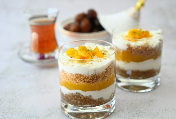 a couple of glasses filled with food on top of a table