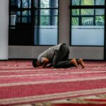 a person kneeling down on a rug in a room