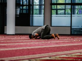 a person kneeling down on a rug in a room