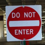 white and red do not enter signboard