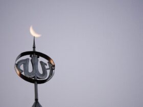 a close up of a clock on top of a building