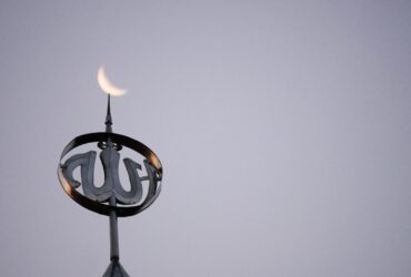 a close up of a clock on top of a building