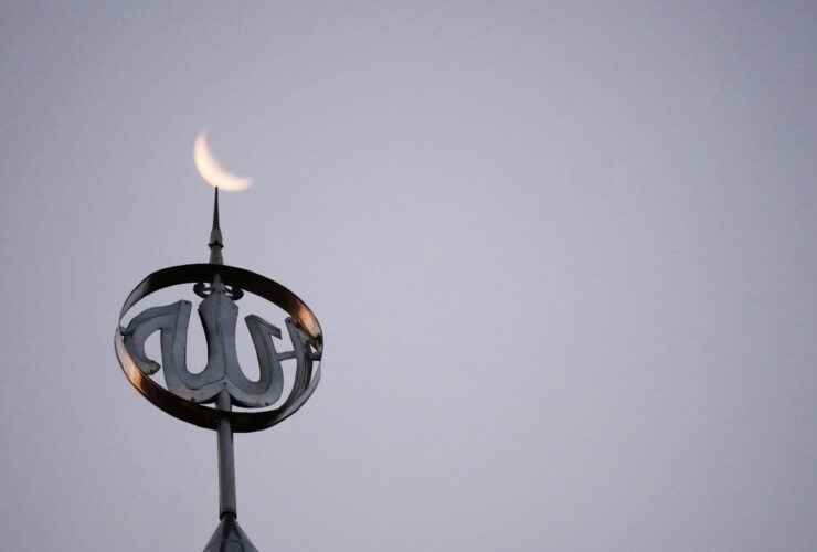 a close up of a clock on top of a building