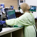 woman in green robe sitting on chair