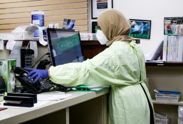 woman in green robe sitting on chair