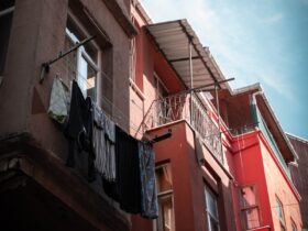 A red building with a balcony and clothes hanging out of it