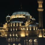 A large building lit up at night with lights on it