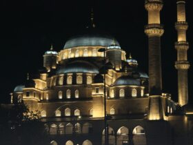 A large building lit up at night with lights on it