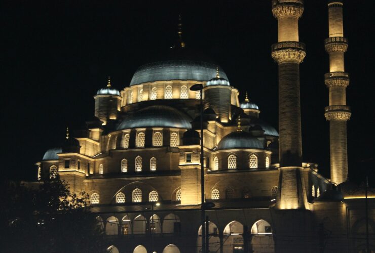 A large building lit up at night with lights on it