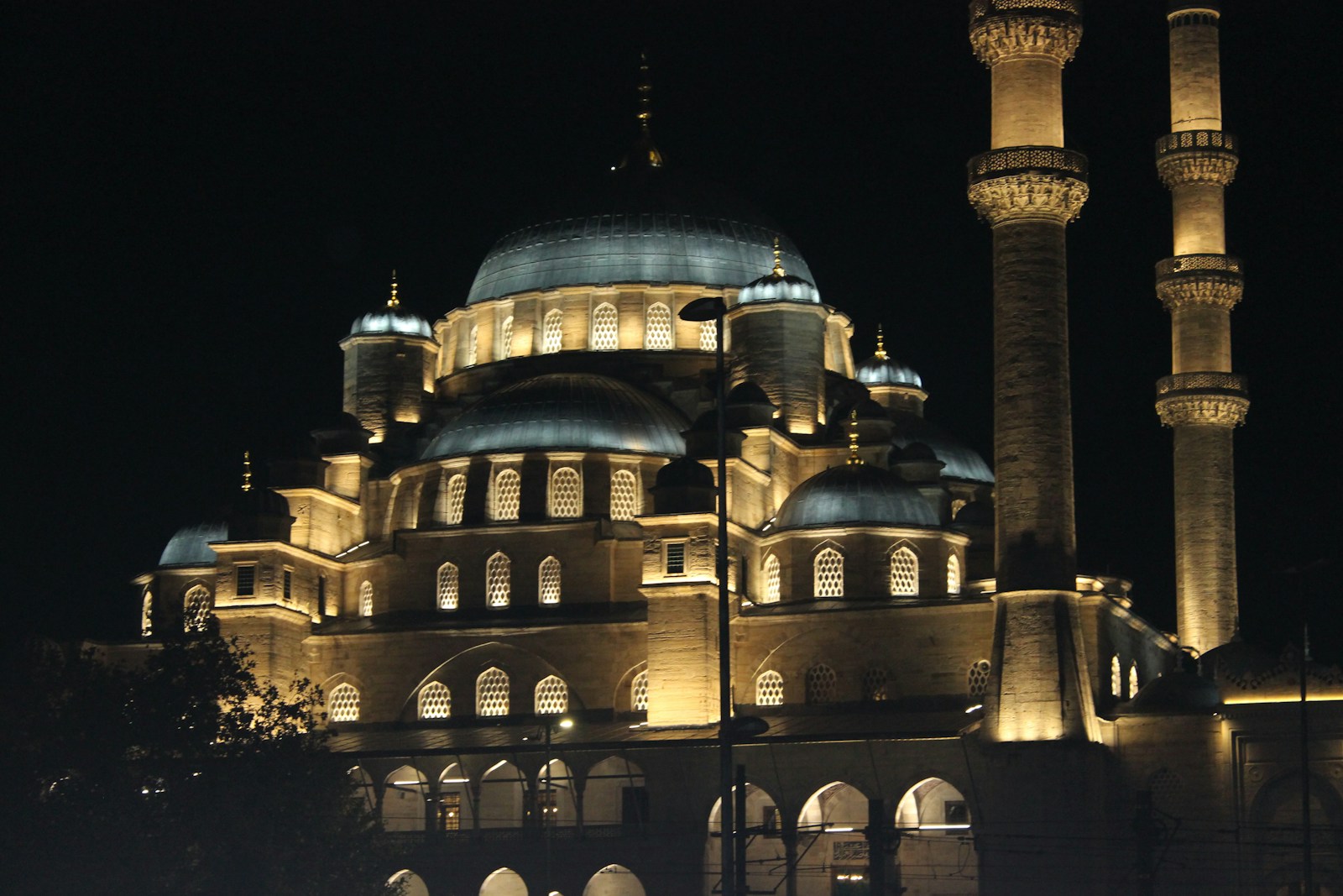 A large building lit up at night with lights on it