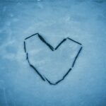a heart drawn in the snow on a cold day