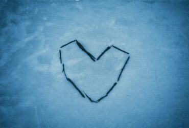 a heart drawn in the snow on a cold day