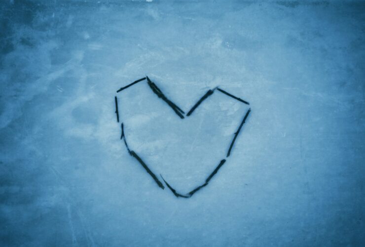 a heart drawn in the snow on a cold day