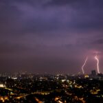 a view of a city at night with lightning