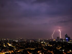 a view of a city at night with lightning