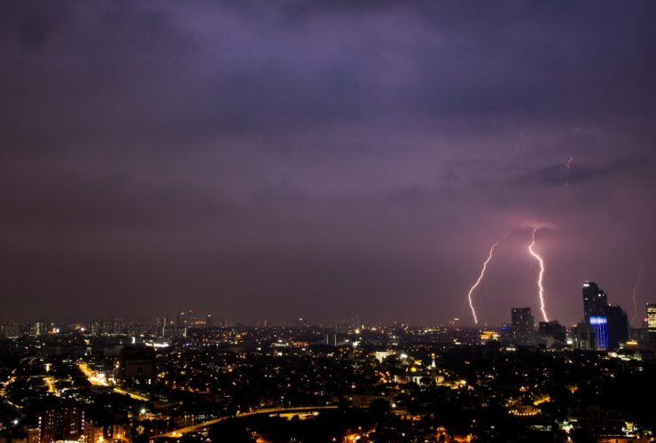 a view of a city at night with lightning