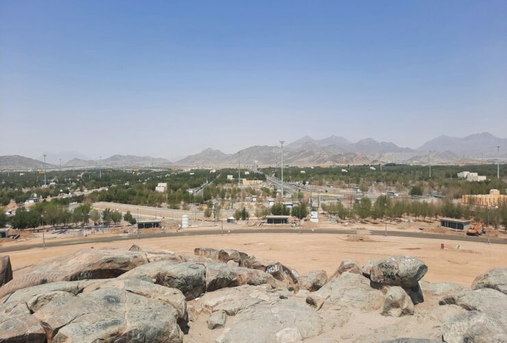 a rocky area with a city in the background