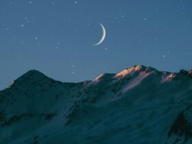crescent moon above mountain