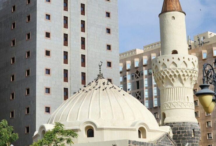 a large white building with a clock on it's side