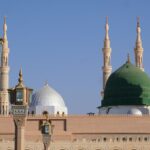The Green Dome and minarets of Al-Masjid an-Nabawi in Medina under a clear sky